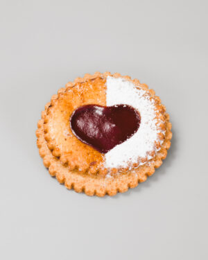 Milan en forme de coeur à la confiture de framboise sur un fond gris